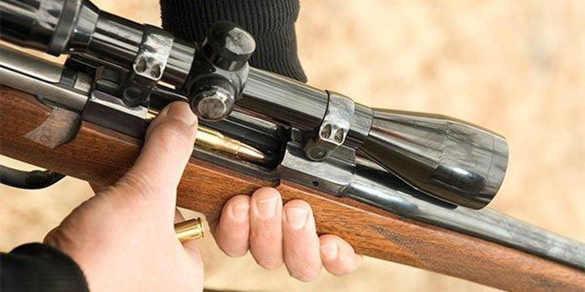 Ruby Ryder shares hands holding a rifle with a scope for the shooting range