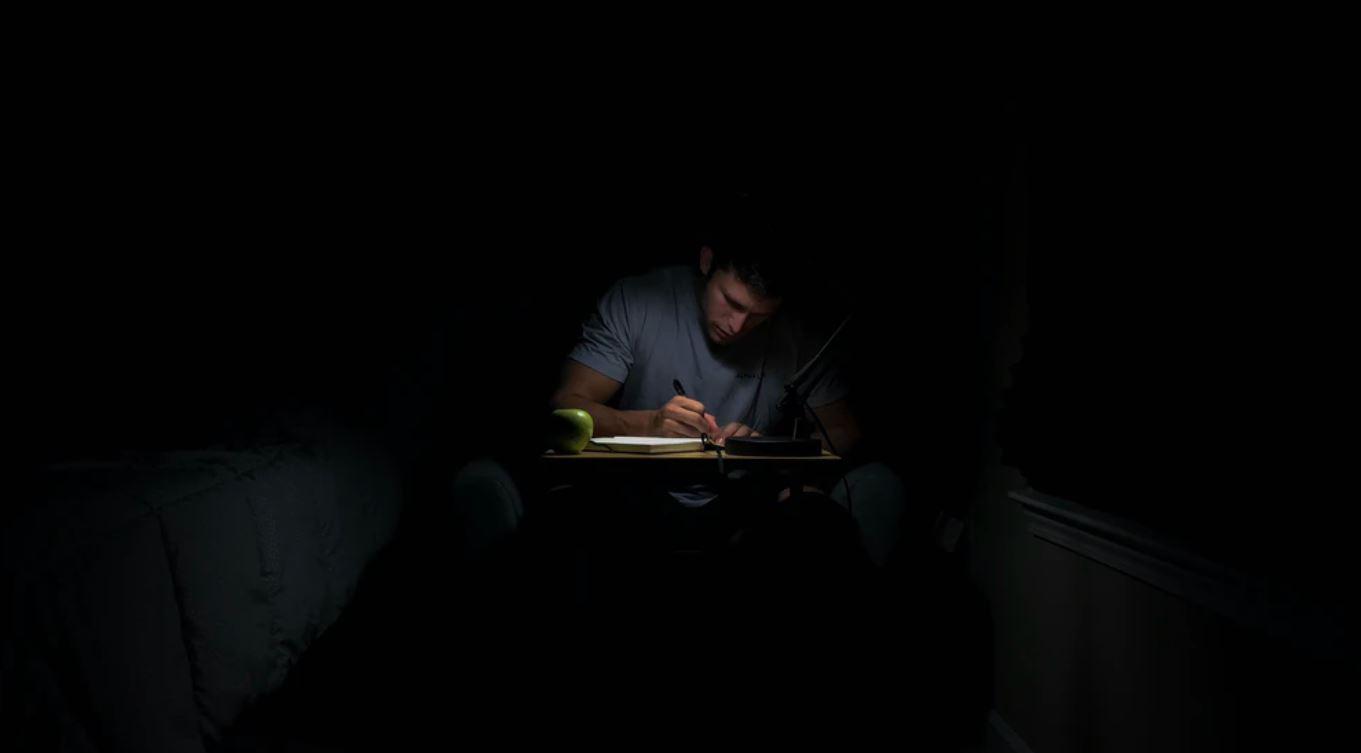 A man writing in the dark displayed on a blog about pegging by Ruby Ryder