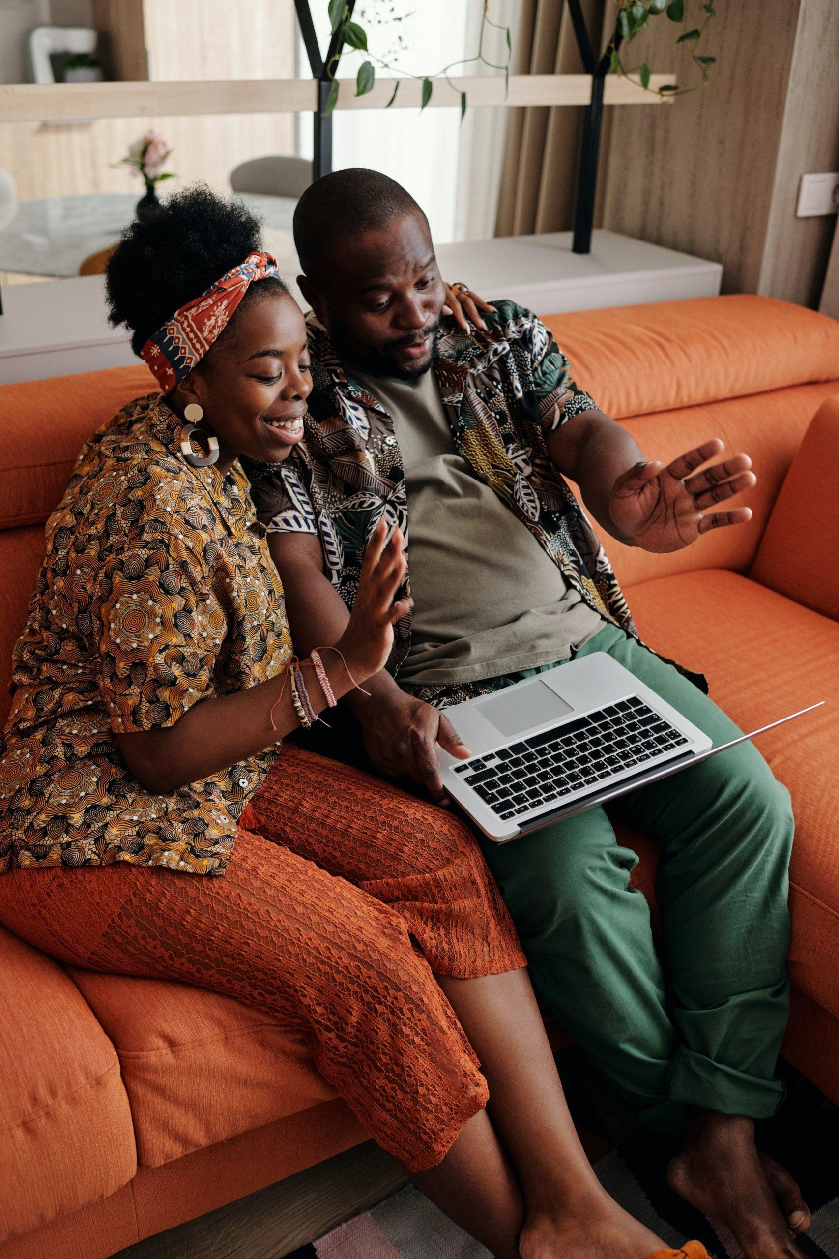 Ruby Ryder shares black couple sitting on couch watching laptop screen and smiling